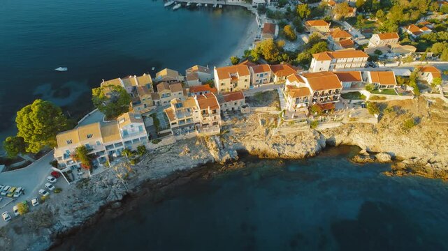 Aerial view of coastal village Assos with colorful houses and small harbor in Cephalonia, Greece