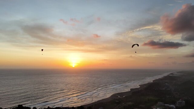 Aerial drone shot of the famous Obelix Sea View viewpoint during a vibrant sunset at the southern coast of Java.