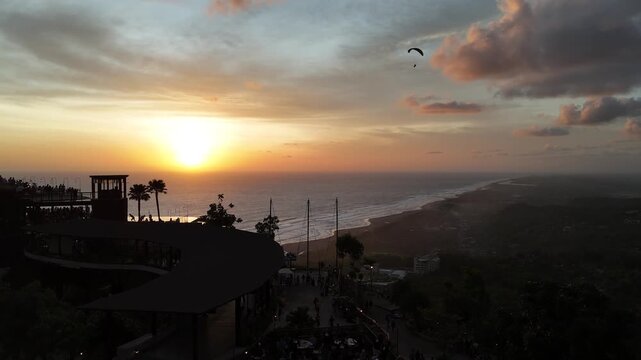 Aerial drone shot of the famous Obelix Sea View viewpoint during a vibrant sunset at the southern coast of Java.