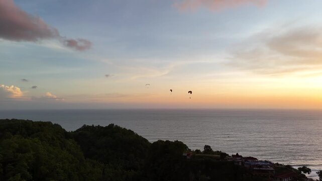 Aerial drone shot of the famous Obelix Sea View viewpoint during a vibrant sunset at the southern coast of Java.