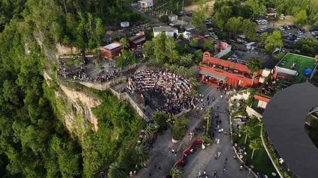 Aerial drone shot of the famous Obelix Sea View viewpoint during a vibrant sunset at the southern coast of Java.