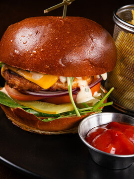 Juicy beef burger with cheese, tomato, onion