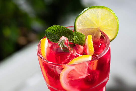 Refreshing red berry lemonade with ice cubes