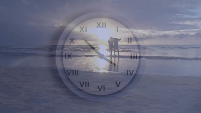 Animation of clock moving fast over people standing on beach by sea