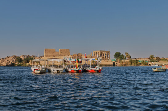 Boats on the Nile River with Philae Temple in the Distance, Aswan Egypt