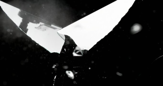 This stunning visual of spontaneous glass shattering against a dark backdrop is perfect for various motion graphics and design projects, making it truly captivating, exciting, and eyecatching