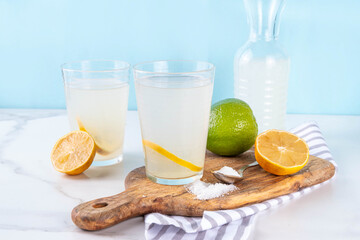 Healthy homemade Electrolyte Drink made with salt, sugar, citrus fruit (lemon and lime) juice. Sport isotonic beverage for good hydration © ricka_kinamoto