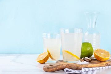 Fototapeta premium Healthy homemade Electrolyte Drink made with salt, sugar, citrus fruit (lemon and lime) juice. Sport isotonic beverage for good hydration