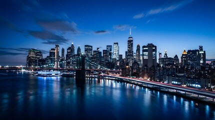 Fototapeta premium City skyline at night with illuminated skyscrapers reflected in the water