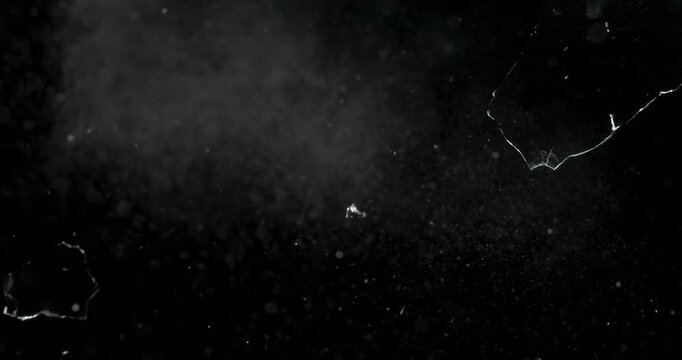 Stunning footage of spontaneous glass breakage on a black background, ideal for motion graphics and visual effects projects