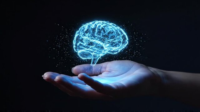 A futuristic, glowing blue brain model is carefully held in a person's hand against a dark background, symbolizing innovation and intelligence