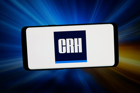 Stuttgart, Germany - 04-02-2026: In this photo illustration, the logo of Irish building materials company CRH plc is displayed on a smartphone in front of abstract background on computer screen.