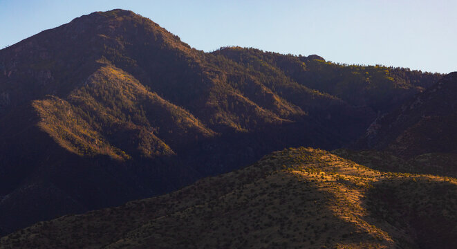 Vibrant gold light on the hills of the Huachuca Mountains just before the sun sets