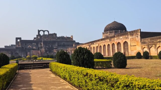 Tarkash Mahal with Solah Khambah masjid and gardening trees at bidar fort, karnataka, india. day time, push in shot, hand held shot, pan shot, 4k.
