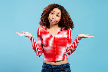Young woman shrugging with doubt and uncertainty