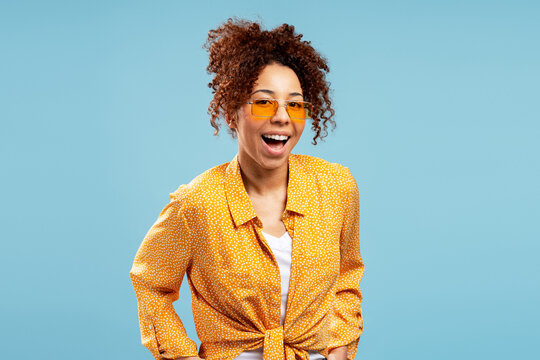 Cheerful young woman enjoying summer wearing sunglasses