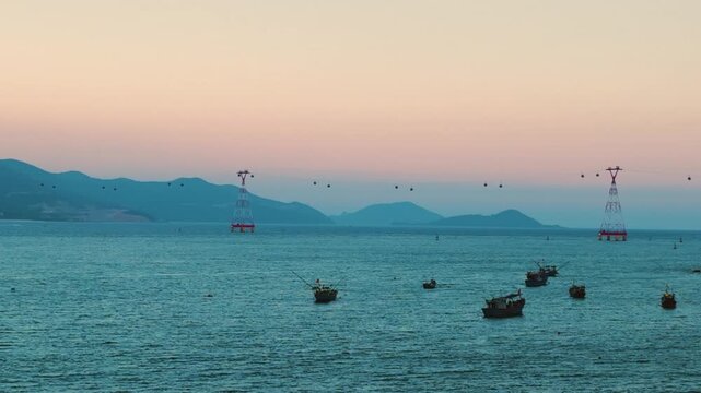 Aerial view of Nha Trang bay with Vinpearl cable car and fishing boats at twilight
local fishing boats rest in the calm waters of the Lang Chut port creating unique visual blend of world class tourism