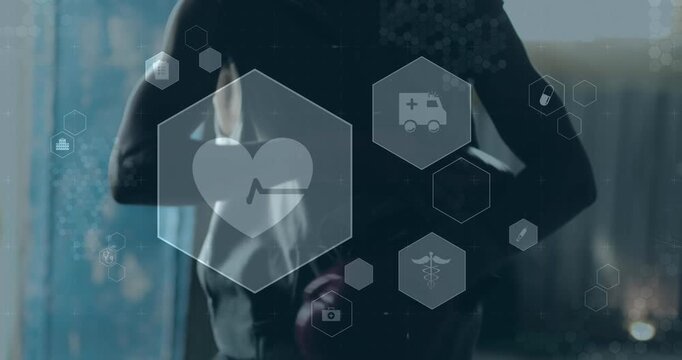 Animation of medical and health icons over african american man with boxing gloves on in gym