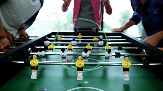 Animation of circle over diverse group of business people playing table football