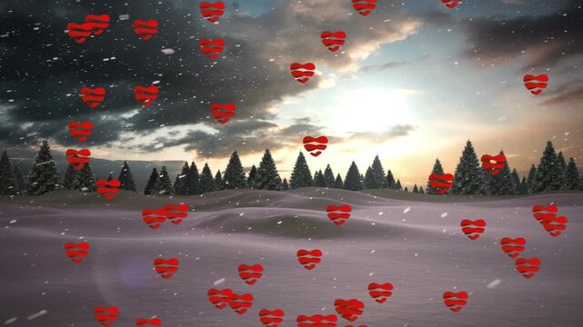 Animation of hearts and snow falling over winter landscape