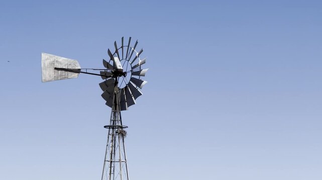 Windmill wind pump borehole in arid landscape, South Africa