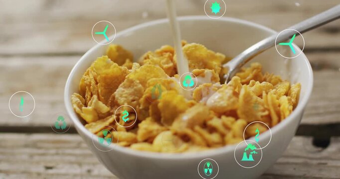 Vertical video: Milk pouring into bowl on table splashing cereal, teal eco icons drifting for meal