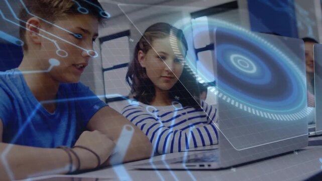 Vertical video: 2 peers sitting in tech lab blue HUD rising and urging boy using trackpad for study