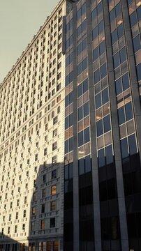 Vertical pattern emphasizing texture in dense city architecture, Consistent window grid complemented by illuminated facades and urban density