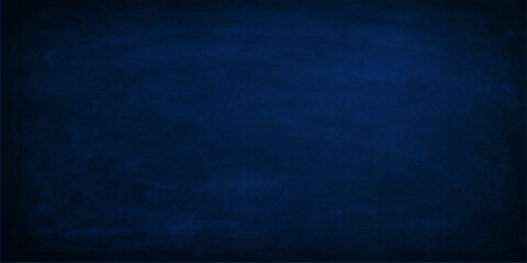 A dark blue grunge background with a textured chalk board surface and vintage denim fabric pattern creates a rough material wallpaper for a textile design backdrop © MdShakibAhamed
