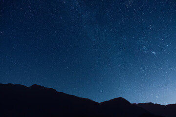 Obraz premium Night landscape, mountains under bright colorful milky way galaxy. Space, night scene time lapse.