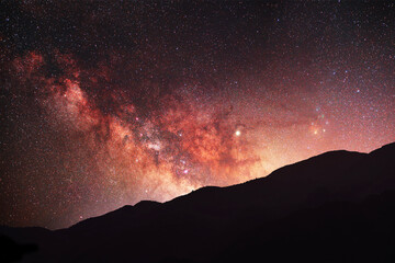 Night landscape, mountains under bright colorful milky way galaxy. Space, night scene time lapse.