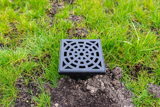Area drainage system installing in green lawn