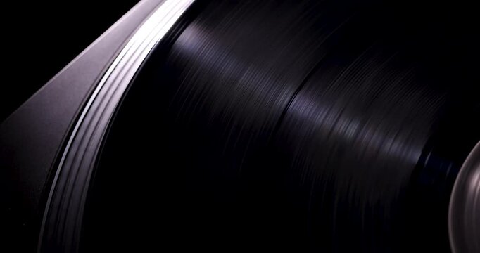 Close-up macro of a Black vinyl record with cinematic light reflections, showcasing luxury texture and contemporary analog music aesthetic.