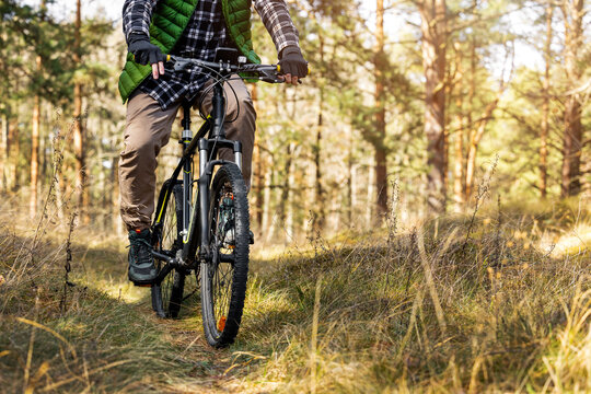Man ride mountain bike on forest trail. Active healthy lifestyle. copy space