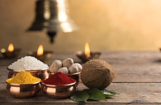 Traditional Hindu pooja ingredients with copper bowls and copy space