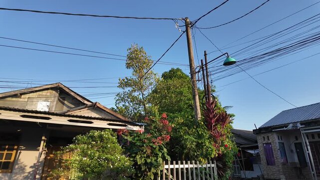 Quiet residential street under a clear blue sky in the afternoon.