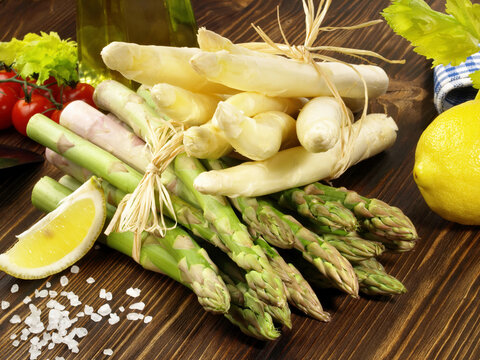 Green and White Asparagus on wooden Background
