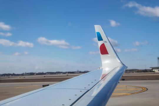 The wing of an American Airlines airplane isolated against the sky (Minneapolis, USA - March 13, 2026). Editorial Use Only.