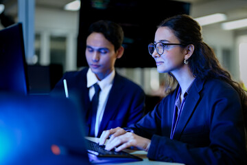 Data science professionals evaluating algorithmic machine learning models. Female tech analyst programming artificial intelligence neural networks code. © ultramansk