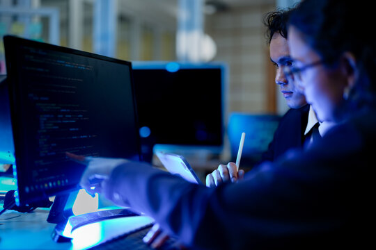 Senior software engineer debugging backend architecture syntax with stylus. DevOps specialists collaborating on cloud infrastructure deployment code.
