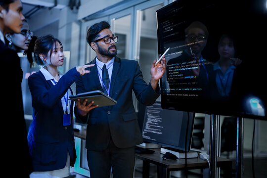 Senior software architect conducting rigorous backend code review with development team. Technical lead analyzing syntax optimization strategies on digital interface.