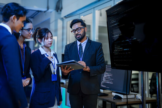Artificial intelligence research team evaluating neural network algorithm efficiency. Lead data scientist explaining predictive machine learning model to corporate analysts.