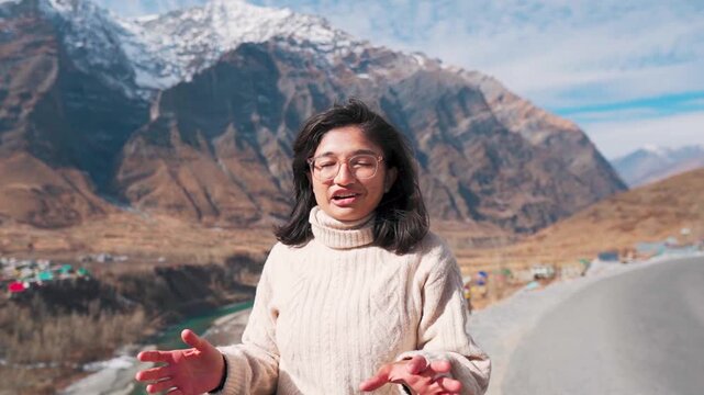 Portrait of Indian woman vlogging in Himalaya mountains at Lahaul, Himachal Pradesh, India. Female travel vlogger making travel vlog. Girl vlogging and creating content for social media.