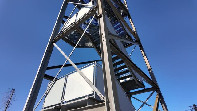 Low angle view of Frauenwald observation tower structure in Bavarian Forest against clear blue sky in Germany