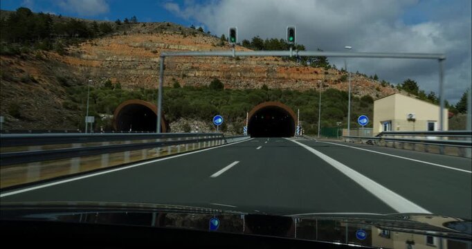 POV driving entering a tunnel in the road