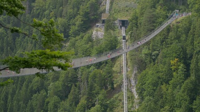 Highline 179 bridge in the Austrian Alps. Tourist suspension bridge in the mountains, dangerous attraction of traveling in Europe.