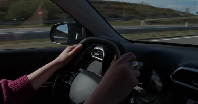 Young woman driving down the roads of Spain