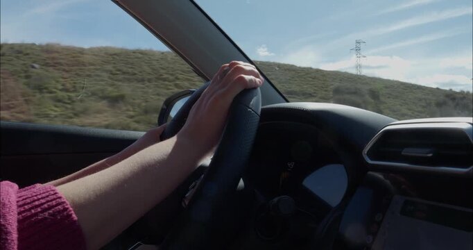 Woman driving down the roads of Spain