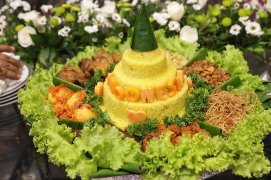 Indonesian Tumpeng Yellow Rice Cone with Traditional Side Dishes for Celebration