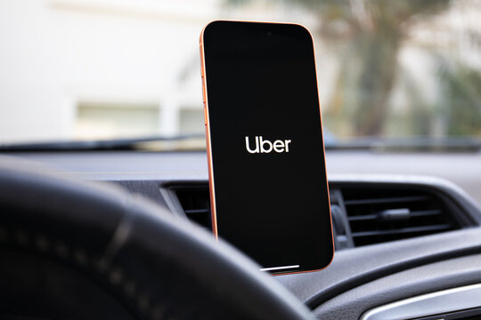 Phone Apple iPhone 17 Pro Max Cosmic Orange with home screen app Taxi UBER background on the screen Car Play